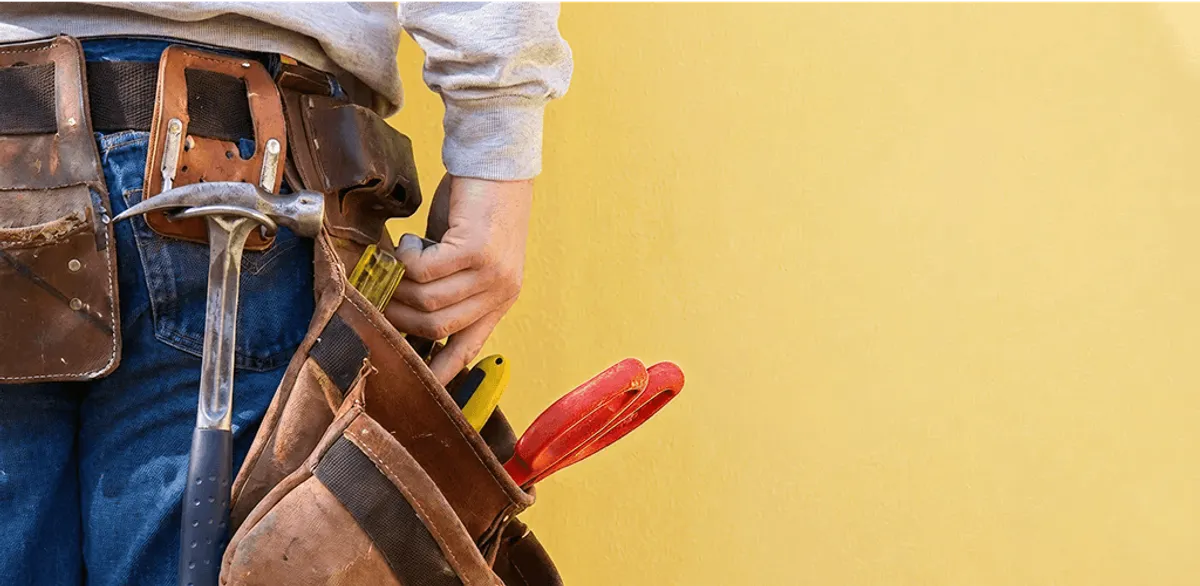 Handyman with tool belt ready for home repairs and maintenance in Irvine, CA