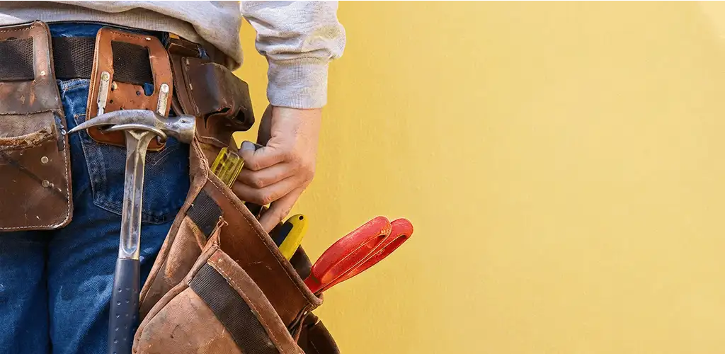 Handyman with tool belt ready for home repairs and maintenance in Irvine, CA