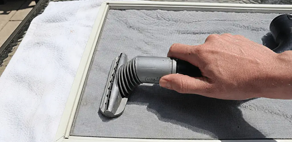 Window screen repair cleaning and fixing a damaged screen mesh in Irvine, CA